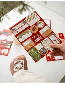 Detailed view of gold foil Christmas gift labels with festive patterns and To-From sections