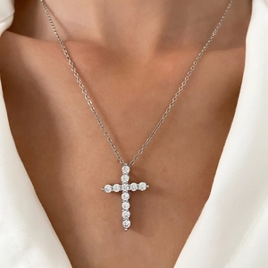 Silver cross necklace with sparkling round-cut crystals for women on a white shirt
