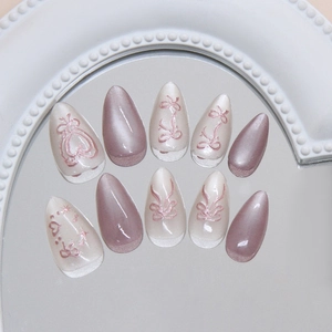 Chic cat-eye 3D bow press-on nails with heart accents in pearlescent rose and white