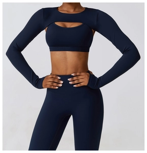 Detail view of navy blue yoga set featuring a unique long sleeve cutout shrug and sports bra