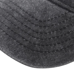 Detailed macro view of the parallel reinforced stitching on a washed cotton baseball cap brim