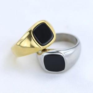 Macro shot of gold and silver vintage signet rings with black square stone inlay