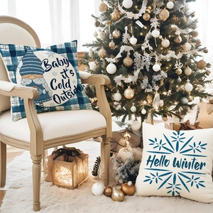 Blue plaid Christmas pillow cases with Gnome and Snowflake prints in festive home setting