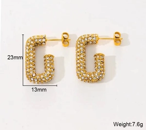 Detailed view of G-shaped gold earrings with rhinestones, 23mm height and 13mm width