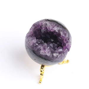 Uruguay natural amethyst geode cluster on a golden metal stand with dark outer shell