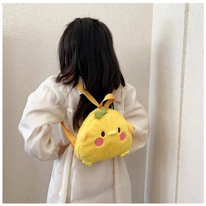 Detail view of a cute plush yellow chick backpack with adjustable straps and sprout accent