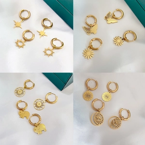 18K gold plated stainless steel hoop earrings with star, eye and sun charms on silk