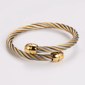 Detailed view of two-tone twisted cable open cuff bracelet in gold and silver finish