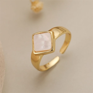 Detail of square pink shell inlay on a 18K gold-plated adjustable copper ring