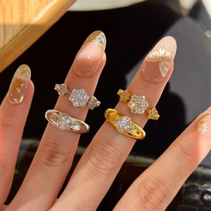 Sparkling crystal flower cluster rings in gold and silver finish on hand