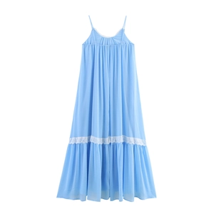 Detailed view of light blue chiffon dress with white lace trim and ruffled hemline