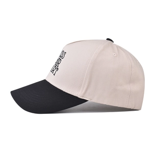 Detail view of cotton baseball cap featuring high-density black embroidered text on crown