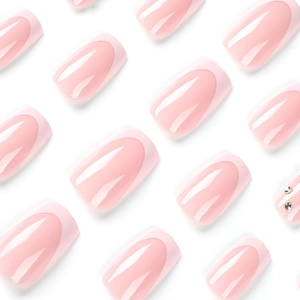 Pink French ombre press-on nails with glossy finish and sparkling rhinestones