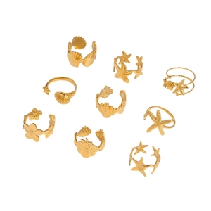 Golden stainless steel ocean ring set featuring starfish and seashell relief designs