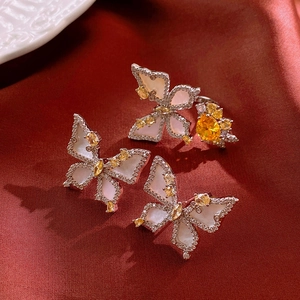 Detail of flower butterfly jewelry set with white mother of pearl and yellow zircon stones