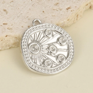 Macro shot of 304 stainless steel irregular round pendant with radial line patterns