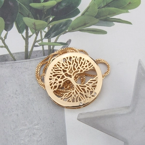 Close-up of gold-plated Tree of Life pendant with zircon crystals and VIDA engraving