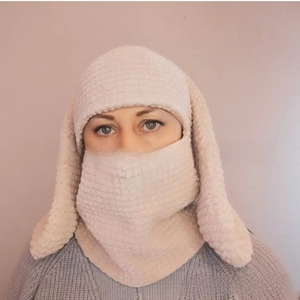 Detailed knit texture of cream rabbit ear balaclava with integrated face mask