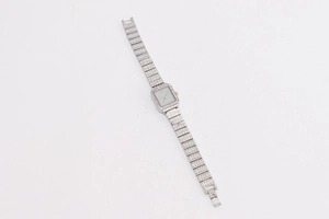 Macro shot of silver square ladies watch with full rhinestone inlay on band and case