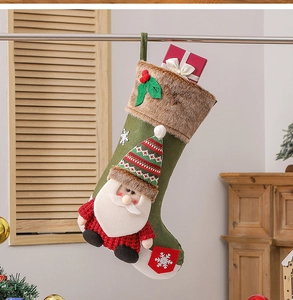 Detail of green Christmas stocking with Santa doll and brown faux fur hanging indoors
