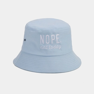 Detail of light blue cotton bucket hat with white 'NOPE' embroidery and metal eyelets