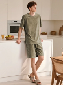 Detail of pea green men's loungewear set in soft terry cloth fabric with drawstring shorts