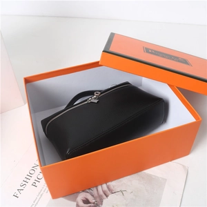 Macro view of black lychee grain leather handbag with silver round zipper pull detail
