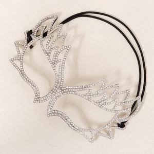 Detailed close-up of sparkling rhinestone masquerade mask with silver wing motifs