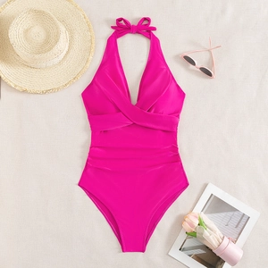 Detail of rose red one-piece swimsuit featuring halter neck and ruched slimming texture