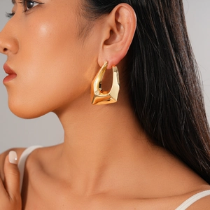 Close-up of a model wearing a 18K gold plated irregular geometric earring on the ear