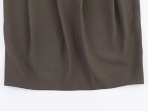 Detailed macro view of dark grey twill suit fabric texture and hemline craftsmanship