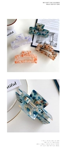Close-up of assorted rectangle hair claws with terrazzo and marble texture patterns