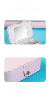 Pink PU leather jewelry box detail with makeup mirror and velvet compartments