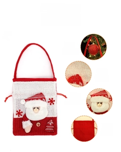 Detail view of knitted Christmas gift bag with plush Santa and sequins embroidery
