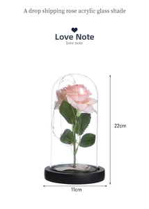 Detail of LED pink rose in glass dome with fairy lights, height 22cm and black base