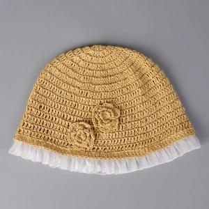 Detail of yellow knit children's sun hat with floral accents and lace mesh brim