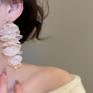 Elegant long chiffon petal tassel earrings with pearls and gold stud on a model