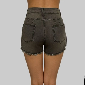 Detailed back view of high-waist denim shorts with distressed frayed hem in dark grey finish
