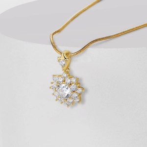 Golden sunburst pendant necklace with sparkling cubic zirconia on a sleek snake chain