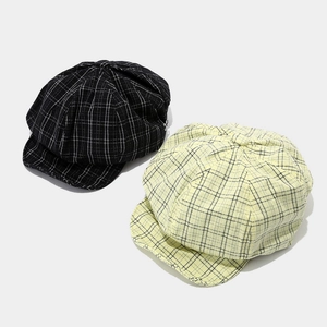 Classic newsboy caps in black and light yellow plaid patterns with soft round crown