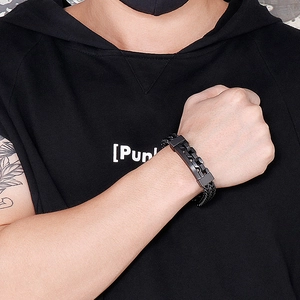 Close-up of a men's black stainless steel bracelet with a hollow square braided design