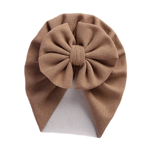 Beige baby turban hat with oversized 3D bow detail and soft cashmere-like knitted fabric