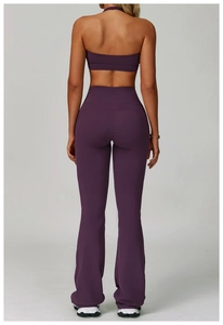Rear view of purple backless yoga set featuring high-waisted flared pants and lifting effect