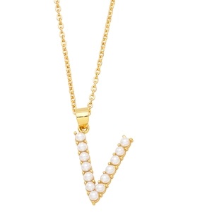 Macro detail of gold-plated necklace featuring a letter V pendant set with white pearls