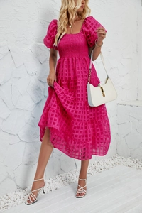 Detail of smocked bodice and textured checkered fabric on magenta puff sleeve dress