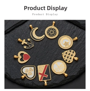 Detail view of assorted gold-plated charms with enamel inlay and rhinestones