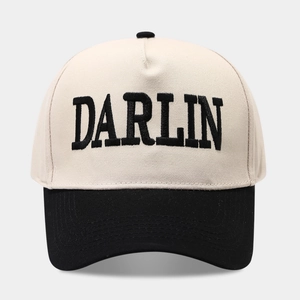 Vintage DARLIN embroidered trucker hat with cream crown and black brim in a classic design