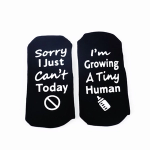 Funny black socks with Sorry I Just Can't and Tiny Human text on a white background