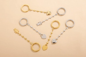 Macro detail of assorted heart and figure charms on gold and silver metal keychains