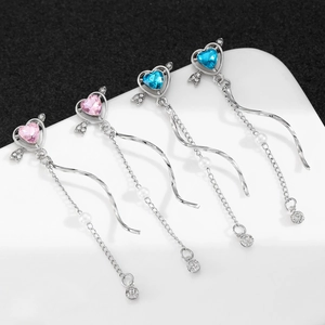 Detail of Cupid heart tassel earrings with pink and blue gemstones and hanging pearls